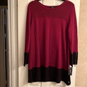 Burgundy knit tunic top with black band detail.